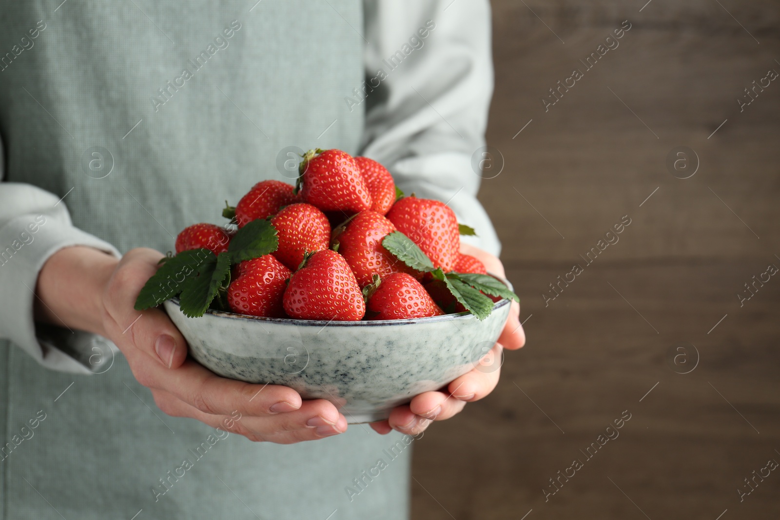 Woman with delicious ripe strawberries indoors, closeup. Space for text Photo of Woman with delicious ripe strawberries indoors, closeup. Space for text