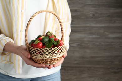 Photo of Woman with delicious ripe strawberries indoors, closeup. Space for text