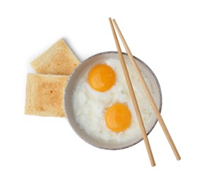 Photo of Half-boiled eggs in bowl, toasted bread and chopsticks isolated on white, top view. Traditional asian breakfast