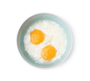 Photo of Half-boiled eggs in bowl isolated on white, top view. Traditional asian breakfast