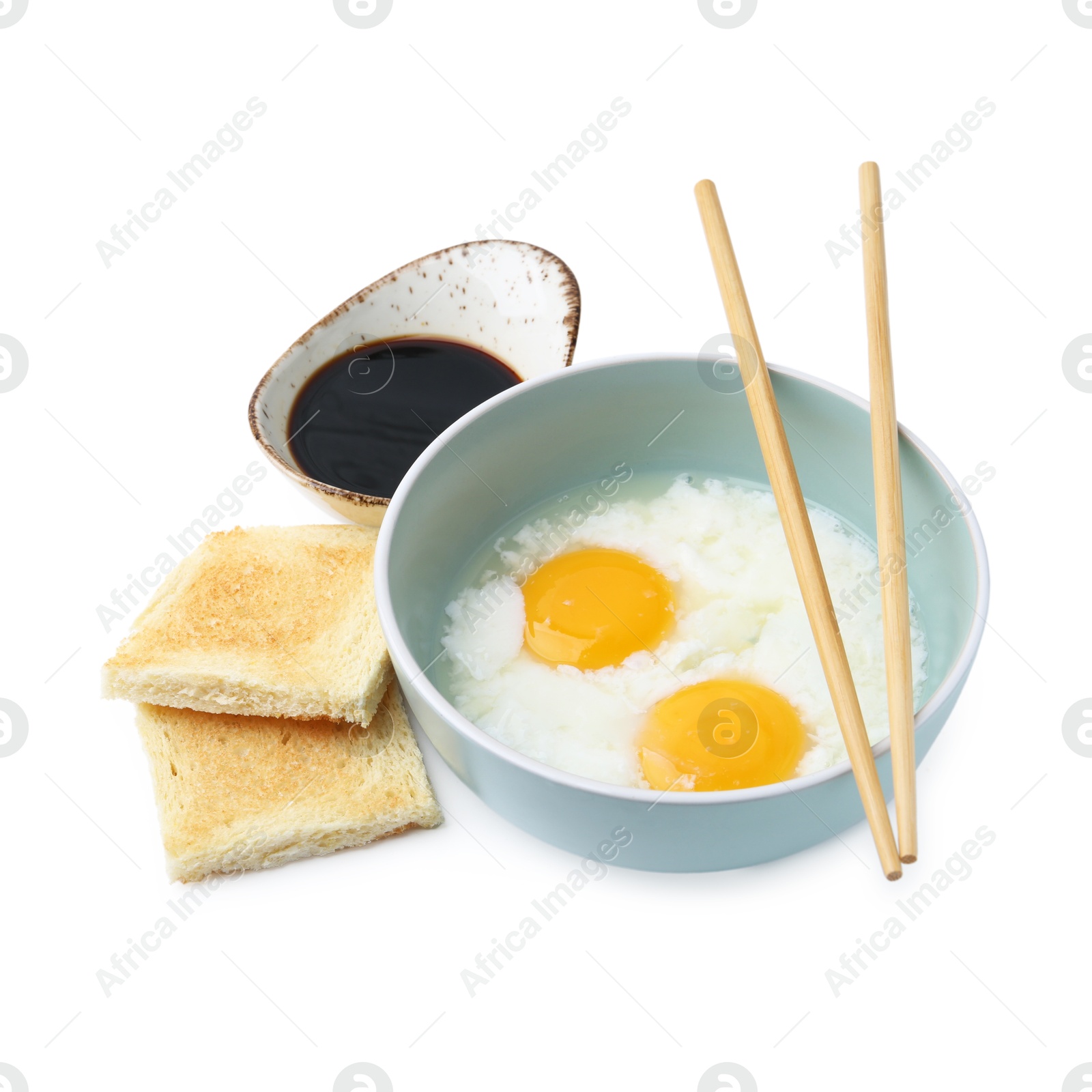 Half-boiled eggs in bowl, soy sauce, toasts and chopsticks isolated on white. Traditional asian breakfast Photo of Half-boiled eggs in bowl, soy sauce, toasts and chopsticks isolated on white. Traditional asian breakfast