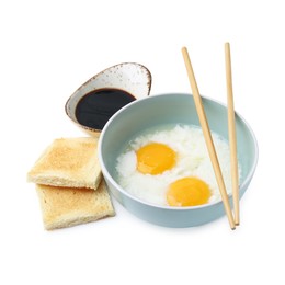 Photo of Half-boiled eggs in bowl, soy sauce, toasts and chopsticks isolated on white. Traditional asian breakfast