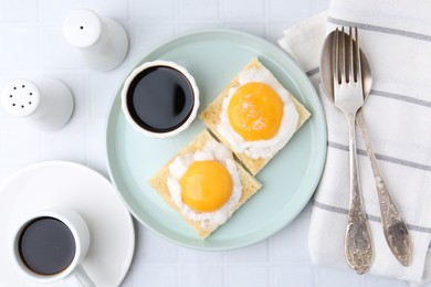 Photo of Tasty kaya toasts with half-boiled eggs served on white tiled table, flat lay. Traditional asian breakfast
