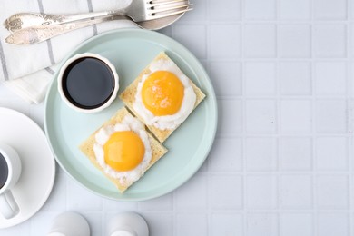 Photo of Traditional asian breakfast with tasty kaya toasts and half-boiled eggs served on white tiled table, flat lay. Space for text
