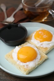 Photo of Tasty kaya toasts with half-boiled eggs served on table, closeup. Traditional asian breakfast