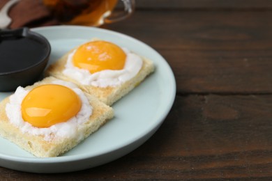 Photo of Traditional asian breakfast with tasty kaya toasts and half-boiled eggs served on wooden table, closeup. Space for text
