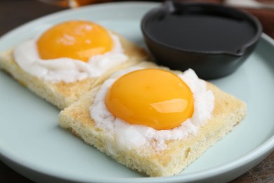 Photo of Tasty kaya toasts with half-boiled eggs served on table, closeup. Traditional asian breakfast