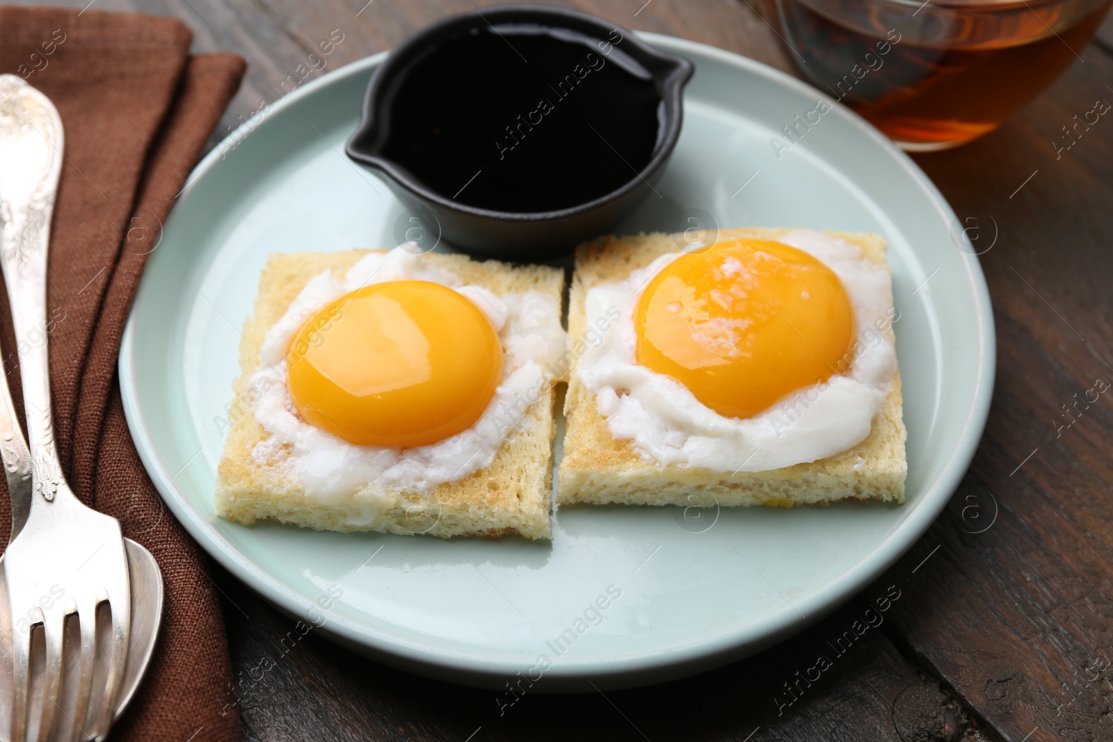 Tasty kaya toasts with half-boiled eggs served on wooden table, closeup. Traditional asian breakfast Photo of Tasty kaya toasts with half-boiled eggs served on wooden table, closeup. Traditional asian breakfast