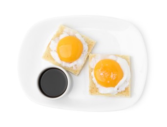 Photo of Tasty kaya toasts with half-boiled eggs and soy sauce isolated on white, top view. Traditional asian breakfast