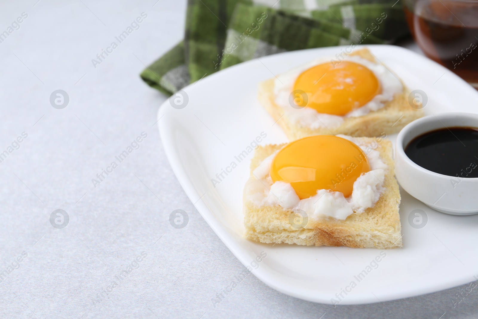 Traditional asian breakfast with tasty kaya toasts and half-boiled eggs served on light grey table, closeup. Space for text Photo of Traditional asian breakfast with tasty kaya toasts and half-boiled eggs served on light grey table, closeup. Space for text
