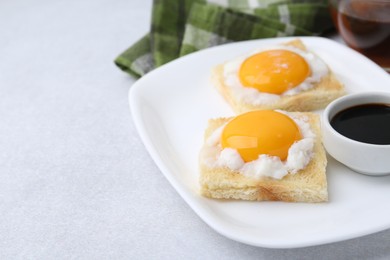 Photo of Traditional asian breakfast with tasty kaya toasts and half-boiled eggs served on light grey table, closeup. Space for text