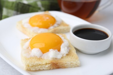 Photo of Tasty kaya toasts with half-boiled eggs served on table, closeup. Traditional asian breakfast