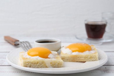 Photo of Tasty kaya toasts with half-boiled eggs served on white wooden table, closeup. Traditional asian breakfast
