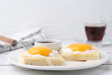 Photo of Tasty kaya toasts with half-boiled eggs served on white wooden table, closeup. Traditional asian breakfast