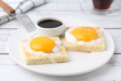 Photo of Tasty kaya toasts with half-boiled eggs served on white wooden table, closeup. Traditional asian breakfast