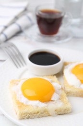 Photo of Tasty kaya toasts with half-boiled eggs served on table, closeup. Traditional asian breakfast
