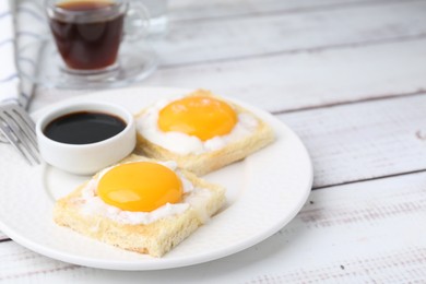 Photo of Traditional asian breakfast with tasty kaya toasts and half-boiled eggs served on white wooden table, closeup. Space for text