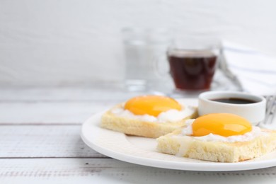 Photo of Traditional asian breakfast with tasty kaya toasts and half-boiled eggs served on white wooden table, closeup. Space for text