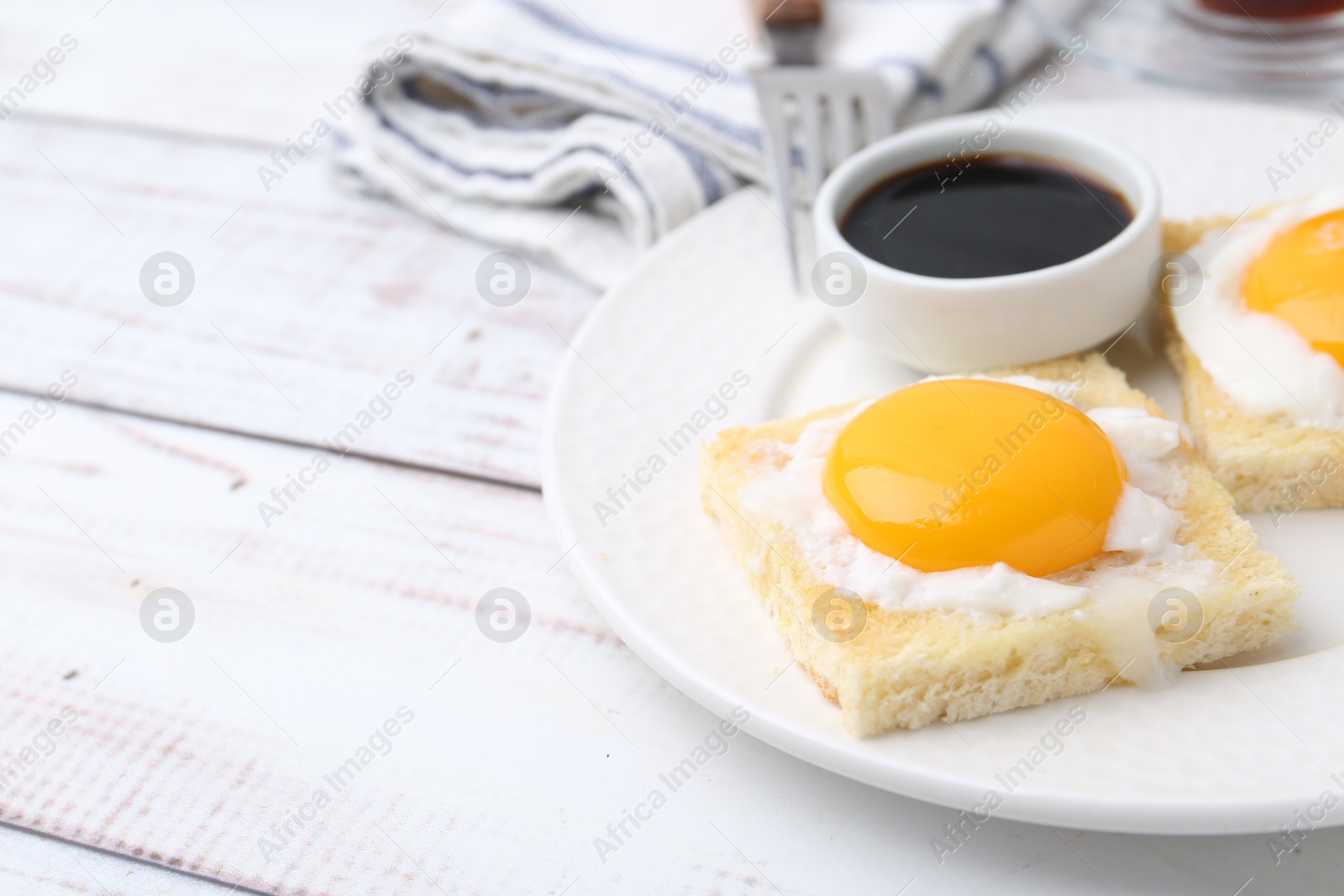 Traditional asian breakfast with tasty kaya toasts and half-boiled eggs served on white wooden table, closeup. Space for text Photo of Traditional asian breakfast with tasty kaya toasts and half-boiled eggs served on white wooden table, closeup. Space for text