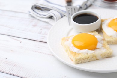 Photo of Traditional asian breakfast with tasty kaya toasts and half-boiled eggs served on white wooden table, closeup. Space for text