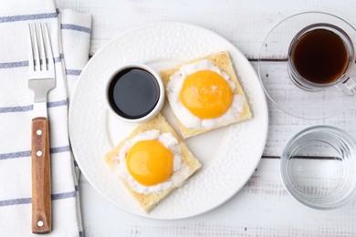 Photo of Traditional asian breakfast with tasty kaya toasts and half-boiled eggs served on white wooden table, flat lay