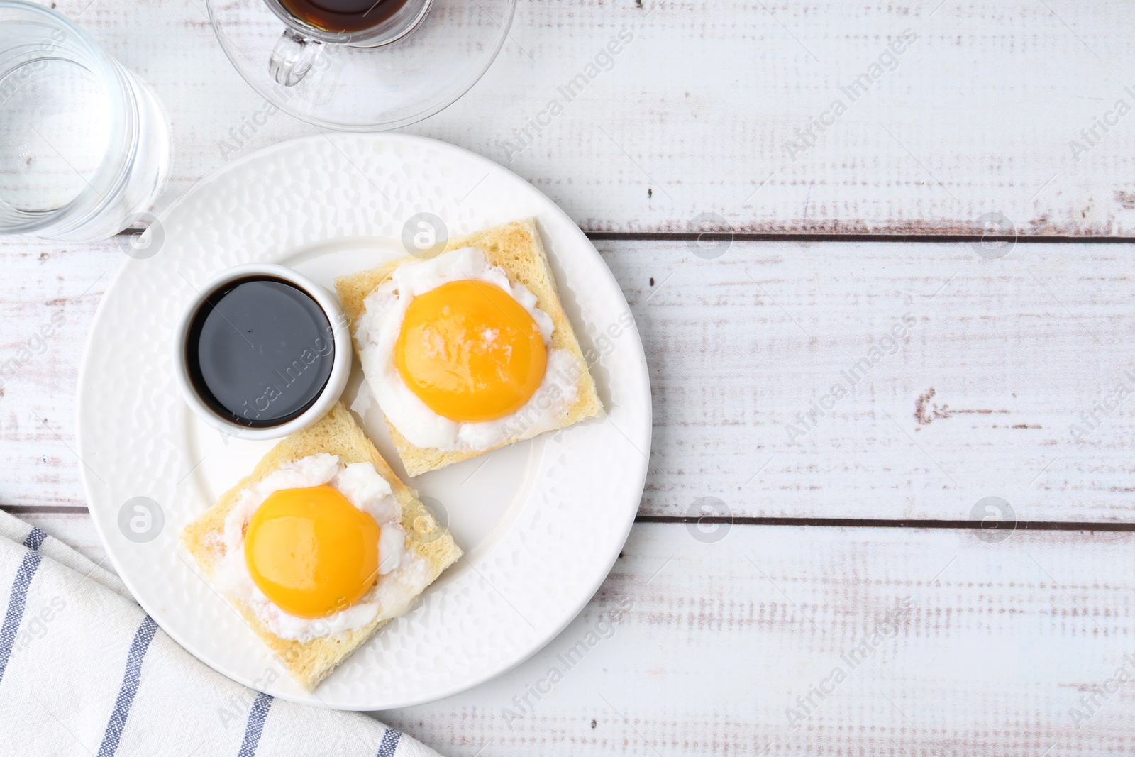 Traditional asian breakfast with tasty kaya toasts and half-boiled eggs served on white wooden table, flat lay. Space for text Photo of Traditional asian breakfast with tasty kaya toasts and half-boiled eggs served on white wooden table, flat lay. Space for text