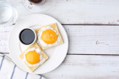 Photo of Traditional asian breakfast with tasty kaya toasts and half-boiled eggs served on white wooden table, flat lay. Space for text
