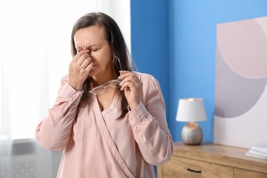 Photo of Woman with glasses suffering from eyestrain at home