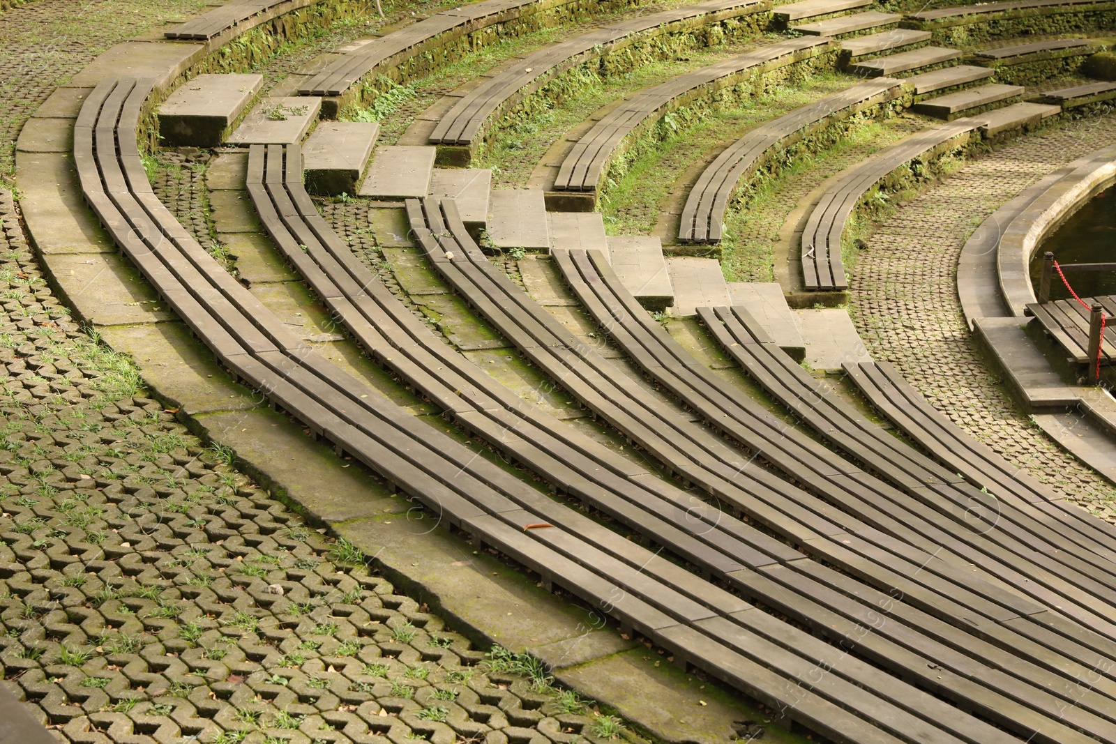 Wooden amphitheater seating and concrete steps outdoors Photo of Wooden amphitheater seating and concrete steps outdoors