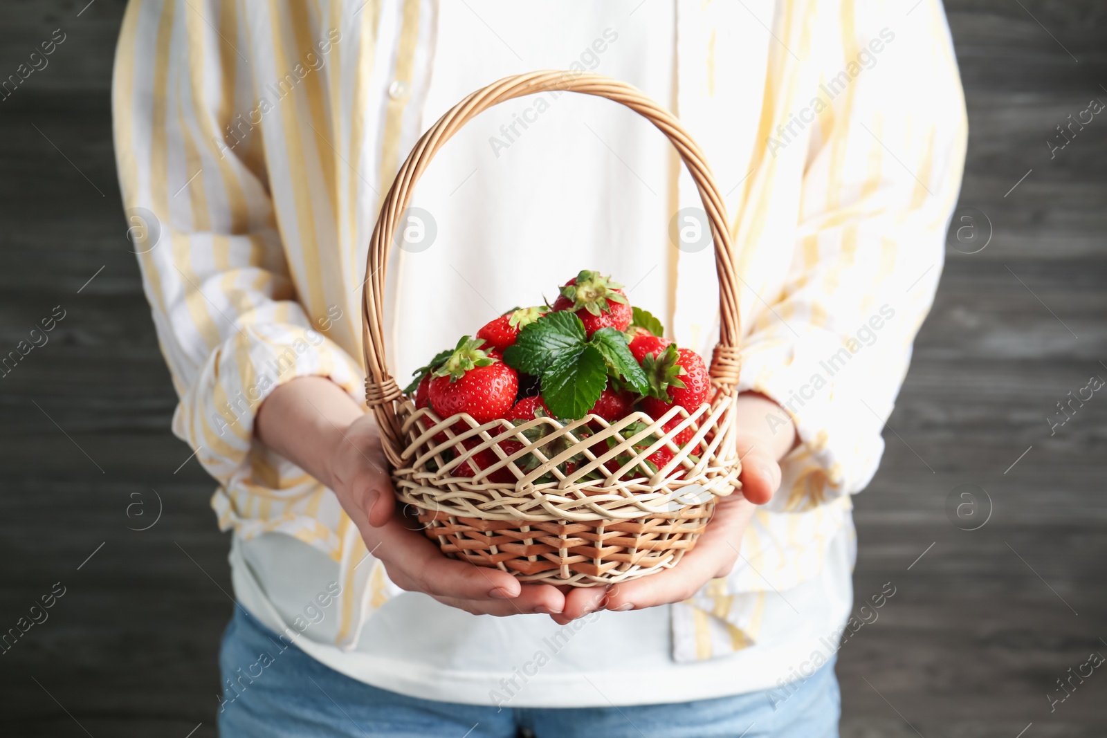 Woman with delicious ripe strawberries indoors, closeup Photo of Woman with delicious ripe strawberries indoors, closeup