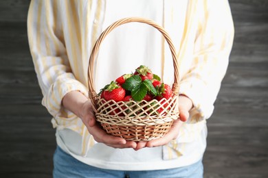 Photo of Woman with delicious ripe strawberries indoors, closeup
