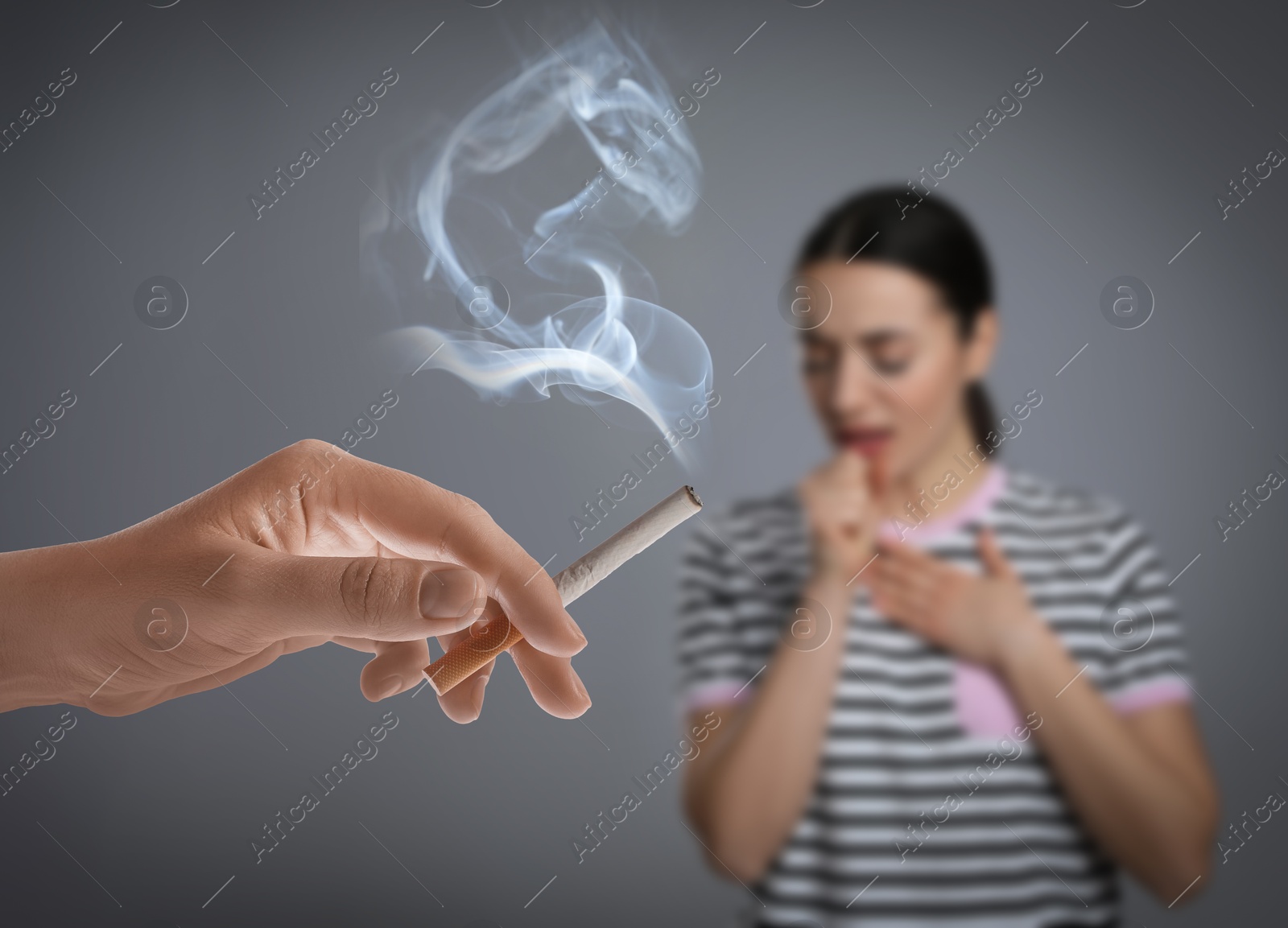 Passive smoking. Woman coughing because of man smoking nearby on grey background. Selective focus Image of Passive smoking. Woman coughing because of man smoking nearby on grey background. Selective focus