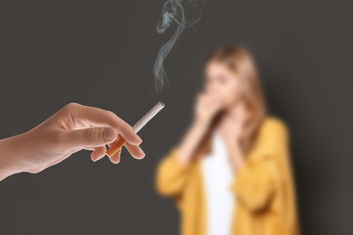 Image of Passive smoking. Girl coughing because of woman smoking nearby on grey background. Selective focus