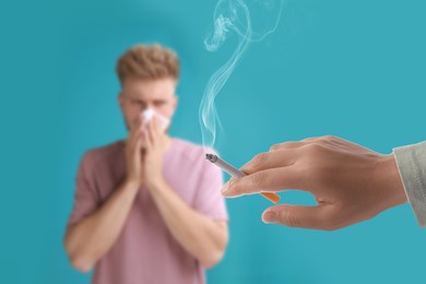 Image of Passive smoking. Man covering his nose with tissue because of woman smoking nearby on light blue background. Selective focus