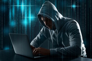 Image of Cyber attack. Hacker working with laptop at table. Binary code around him