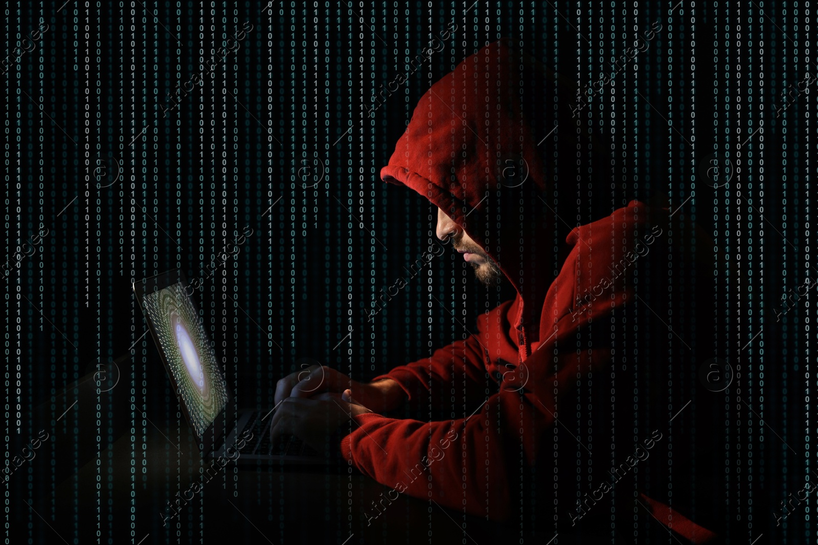 Cyber attack. Hacker working on laptop against black background. Binary code around him Image of Cyber attack. Hacker working on laptop against black background. Binary code around him