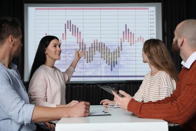 Image of Business people having conference using video projector. Graph on projection screen