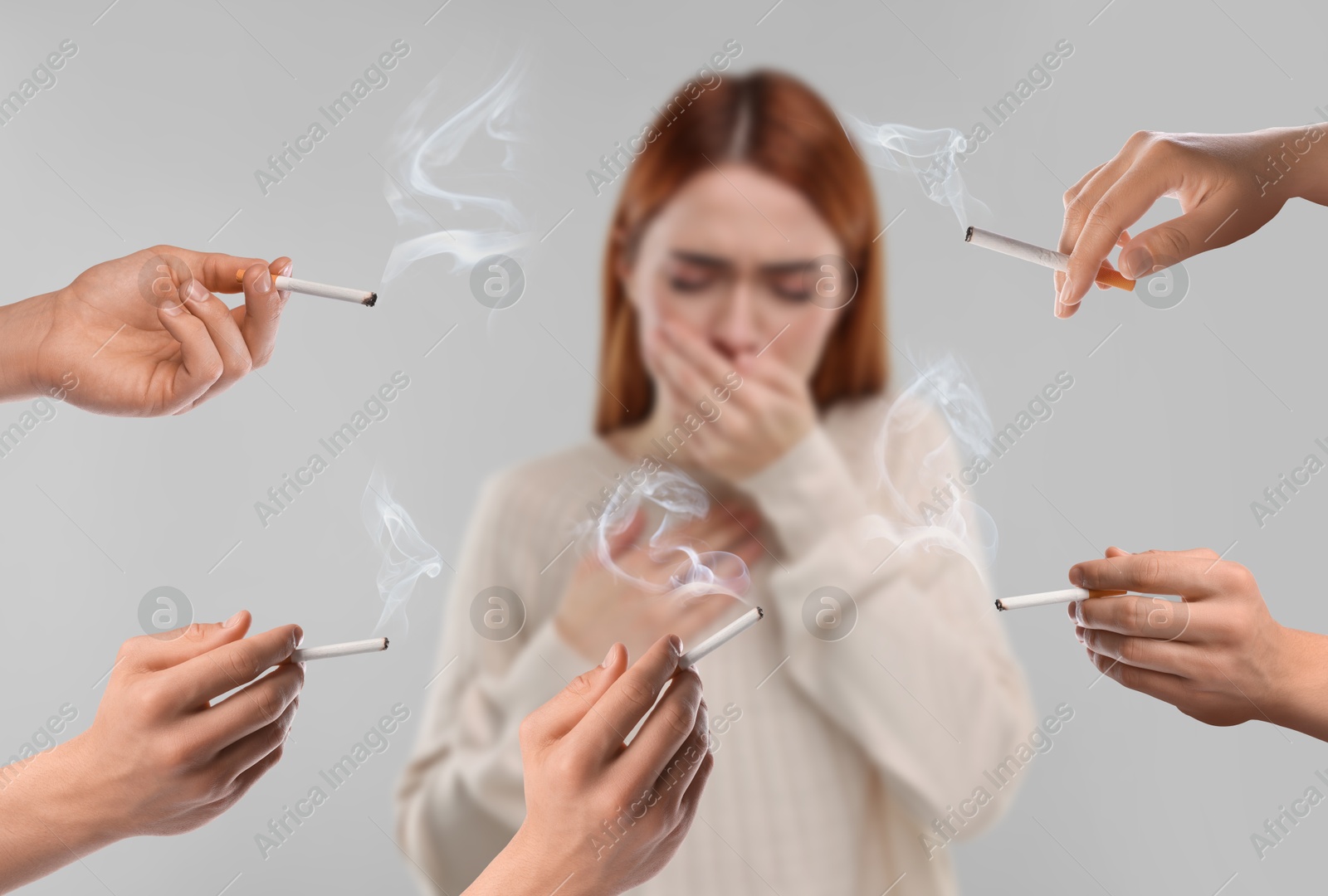 Passive smoking. Woman coughing because of people smoking nearby on light grey background. Selective focus Image of Passive smoking. Woman coughing because of people smoking nearby on light grey background. Selective focus