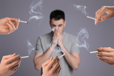 Image of Passive smoking. Man covering his nose with tissue because of people smoking nearby on grey background. Selective focus