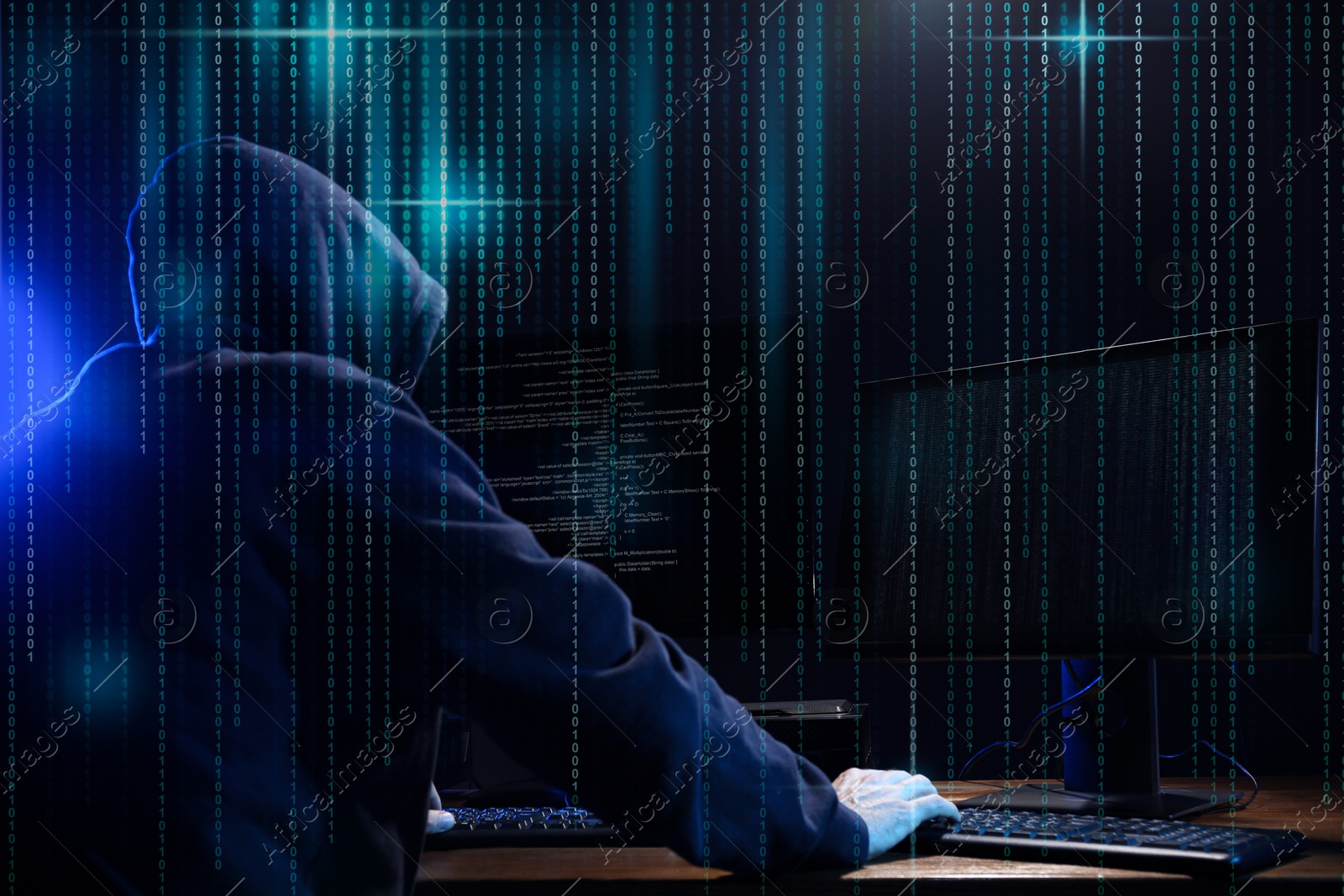 Cyber attack. Hacker working on computers in dark room. Binary code around him Image of Cyber attack. Hacker working on computers in dark room. Binary code around him