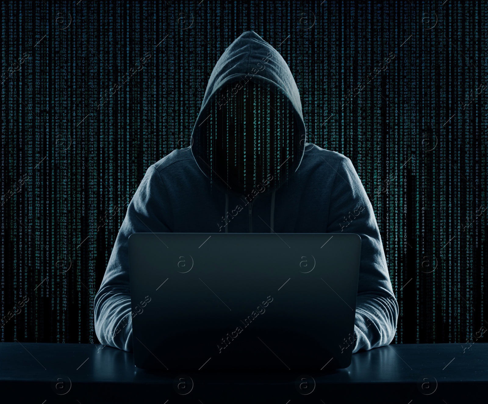 Cyber attack. Anonymous hacker working on laptop at table. Digital code instead of his head Image of Cyber attack. Anonymous hacker working on laptop at table. Digital code instead of his head