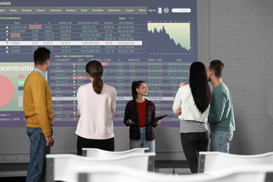 Image of People having business training using video projector in conference room. Graphs and data on projection screen