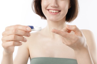 Photo of Woman with contact lens and case on white background, closeup