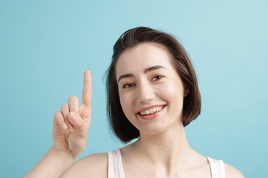 Photo of Woman with contact lens on light blue background
