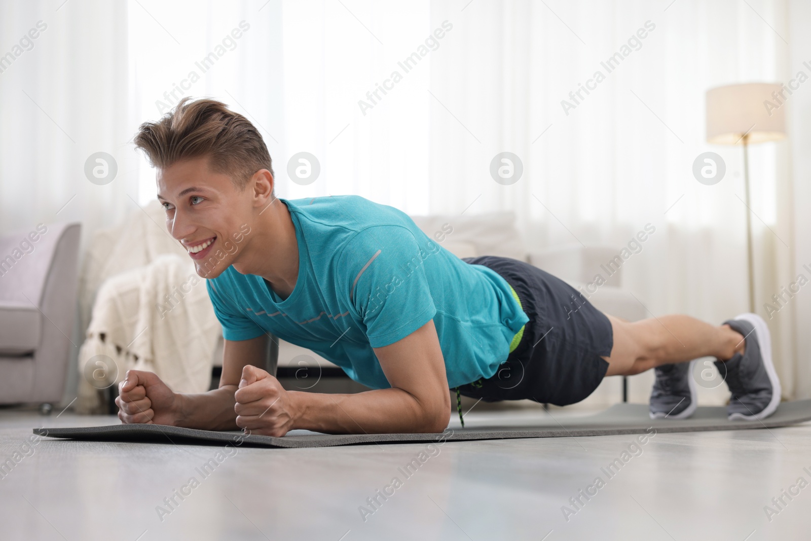 Man doing plank exercise at home. Sport and healthy lifestyle Photo of Man doing plank exercise at home. Sport and healthy lifestyle