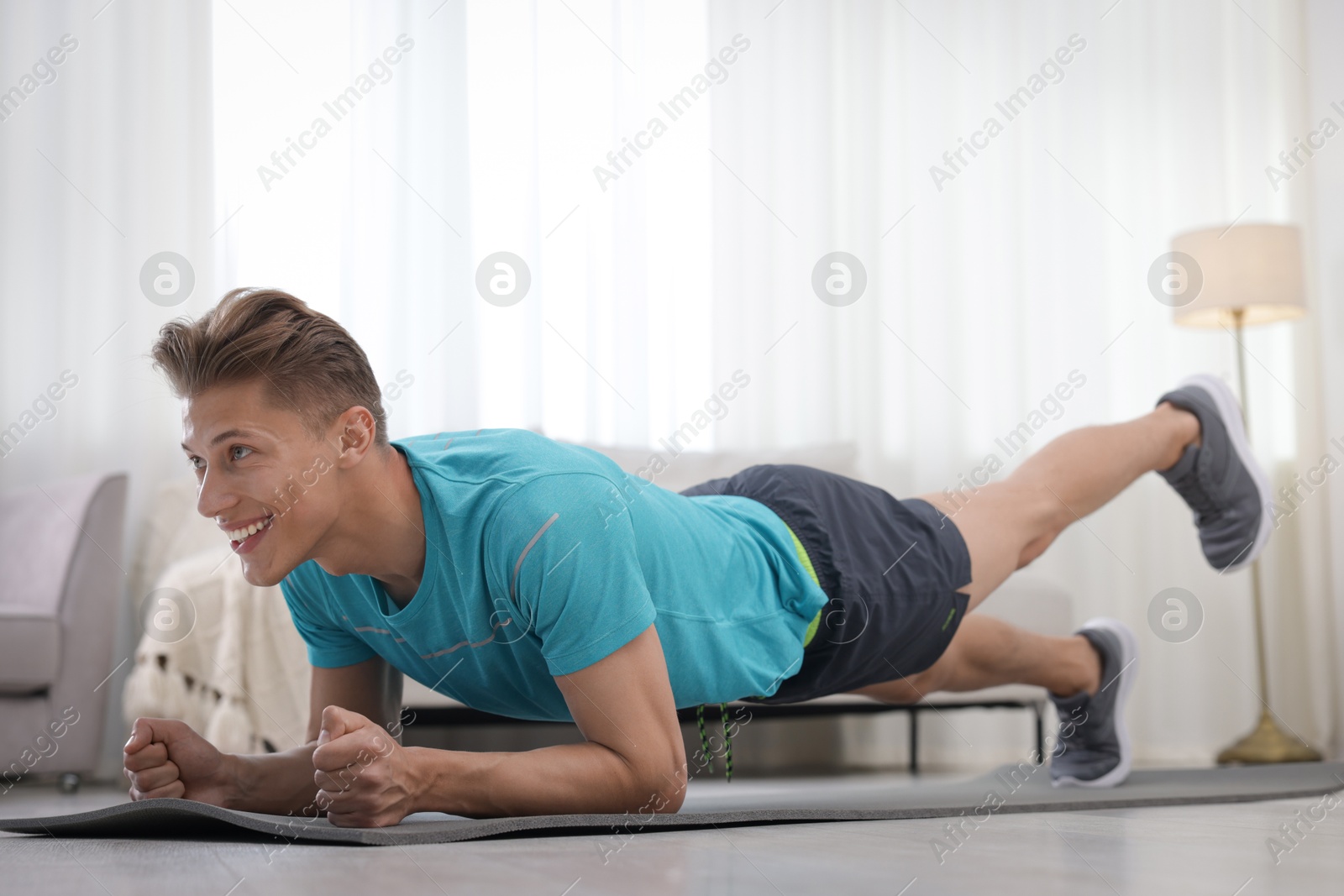 Man doing plank exercise at home. Sport and healthy lifestyle Photo of Man doing plank exercise at home. Sport and healthy lifestyle