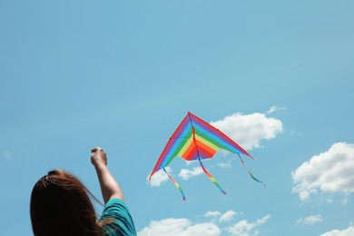 Photo of Woman with colorful kite under blue sky, low angle view