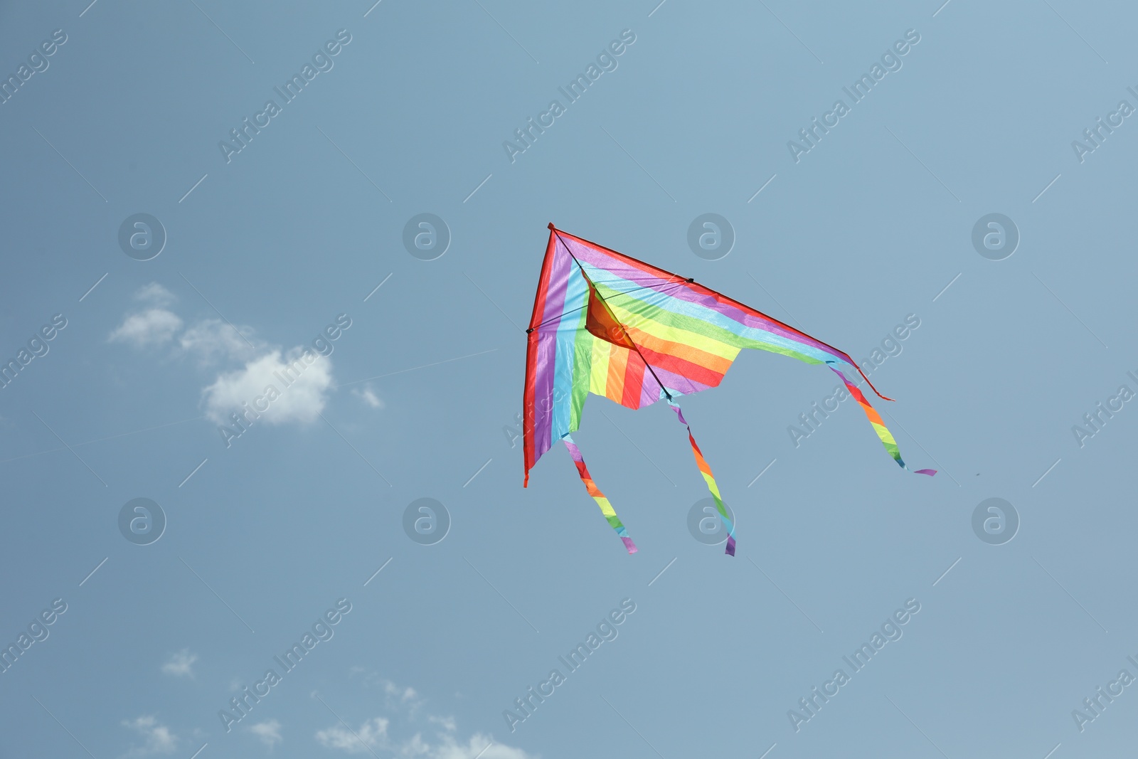 Colorful kite flying in blue sky, low angle view. Space for text Photo of Colorful kite flying in blue sky, low angle view. Space for text