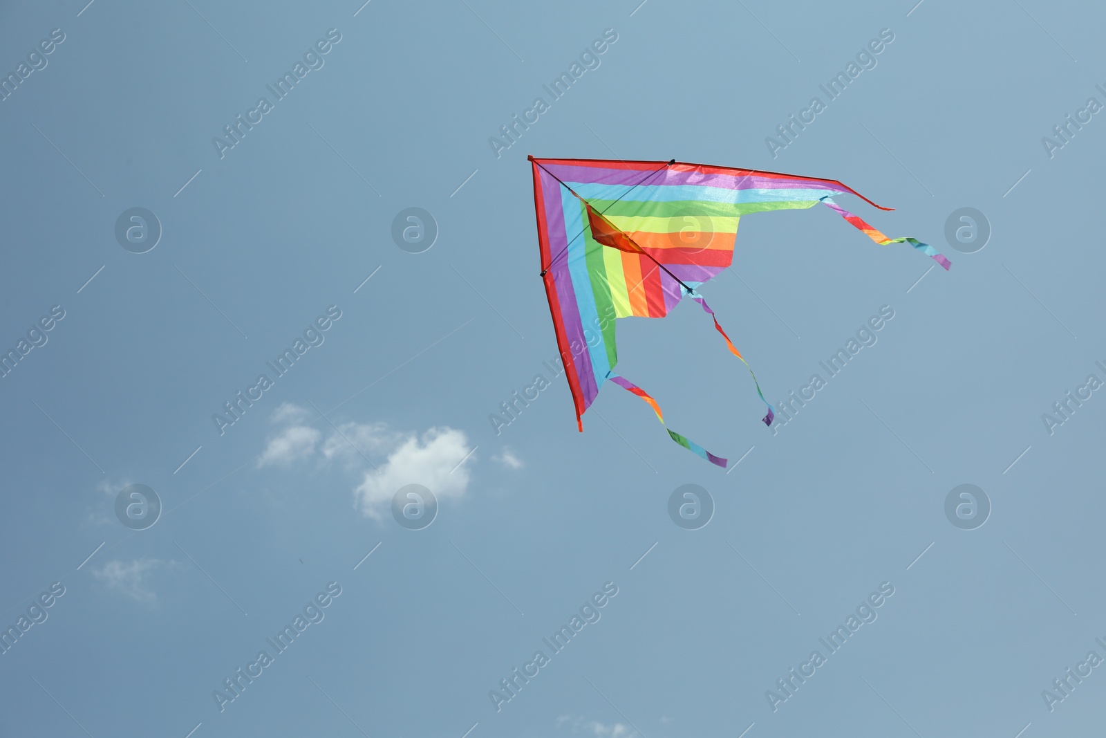 Colorful kite flying in blue sky, low angle view. Space for text Photo of Colorful kite flying in blue sky, low angle view. Space for text