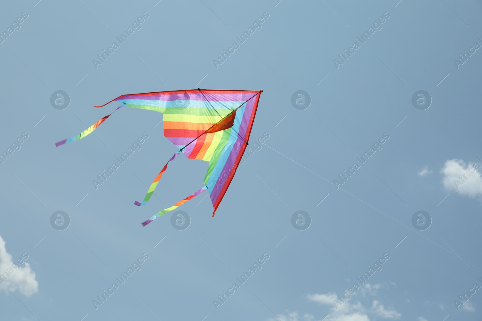 Colorful kite flying in blue sky, low angle view. Space for text Photo of Colorful kite flying in blue sky, low angle view. Space for text